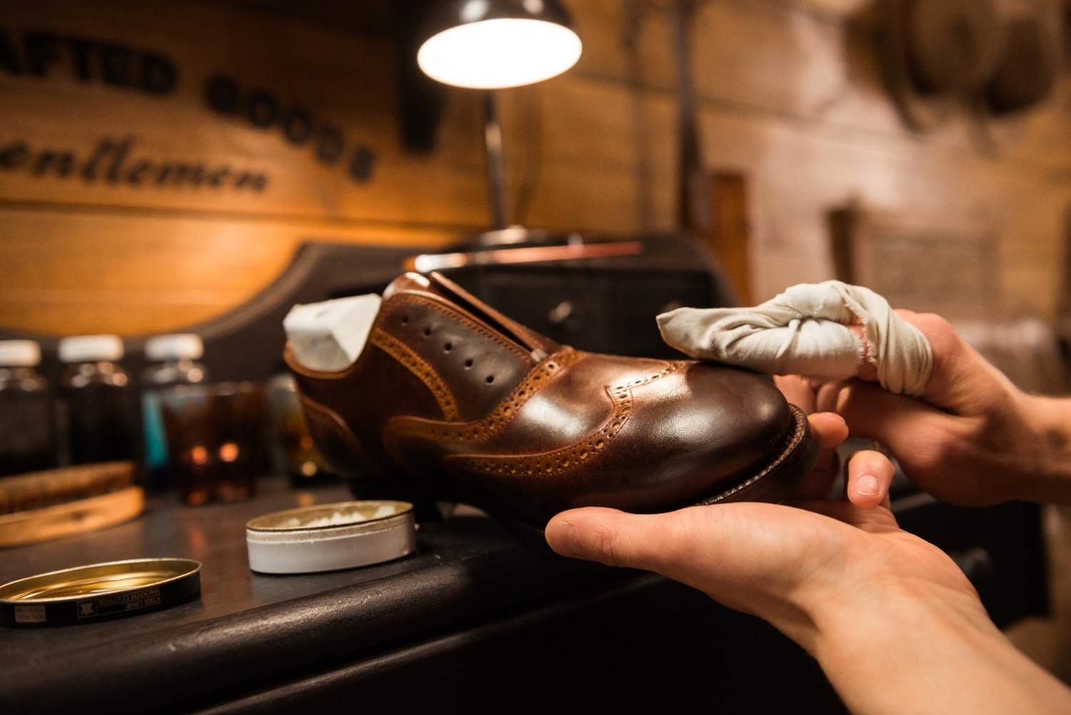 Grand Touch artisan inspecting Footwear